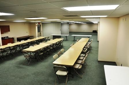 Meeting Room with tables and chairs at the Taylor Sportsplex. 