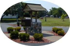 A small wood and stone wishing well.