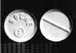 A small, circular, white, "Rohypnol" or Roofie Pill. The front side reads," ROCAE 1."