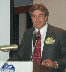 James Gendron speaking at a podium.